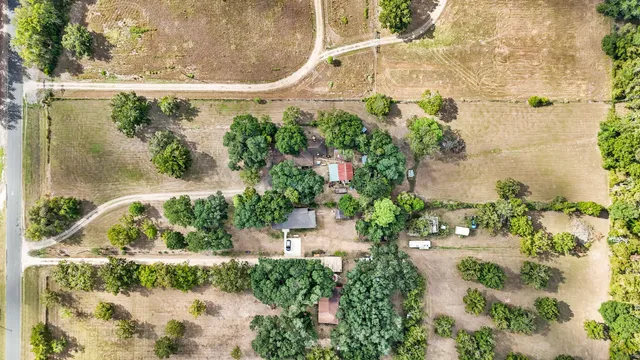 an aerial view of a residential houses with outdoor space