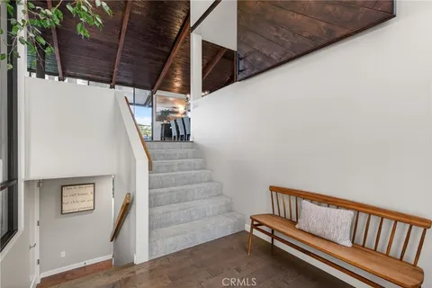 a living room with furniture and a view of kitchen