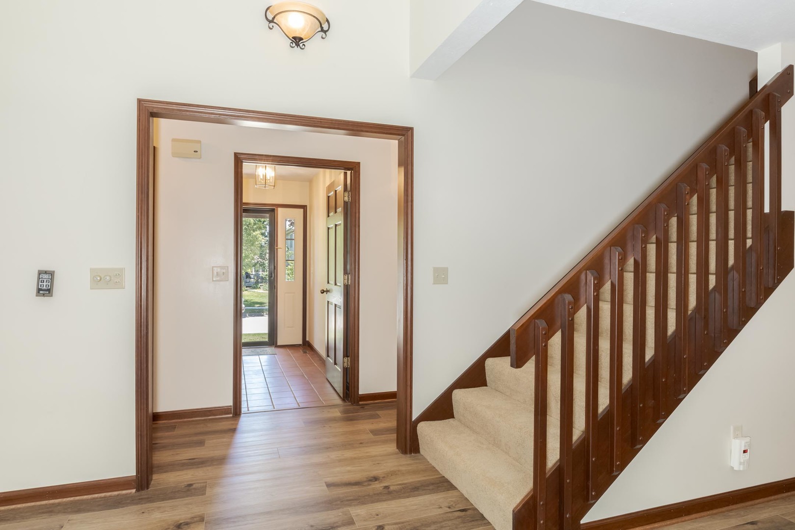 905 Rhymer Drive Normal, IL 61761 - Photo 11 of 47 a view of a hallway with wooden floor and stairs
