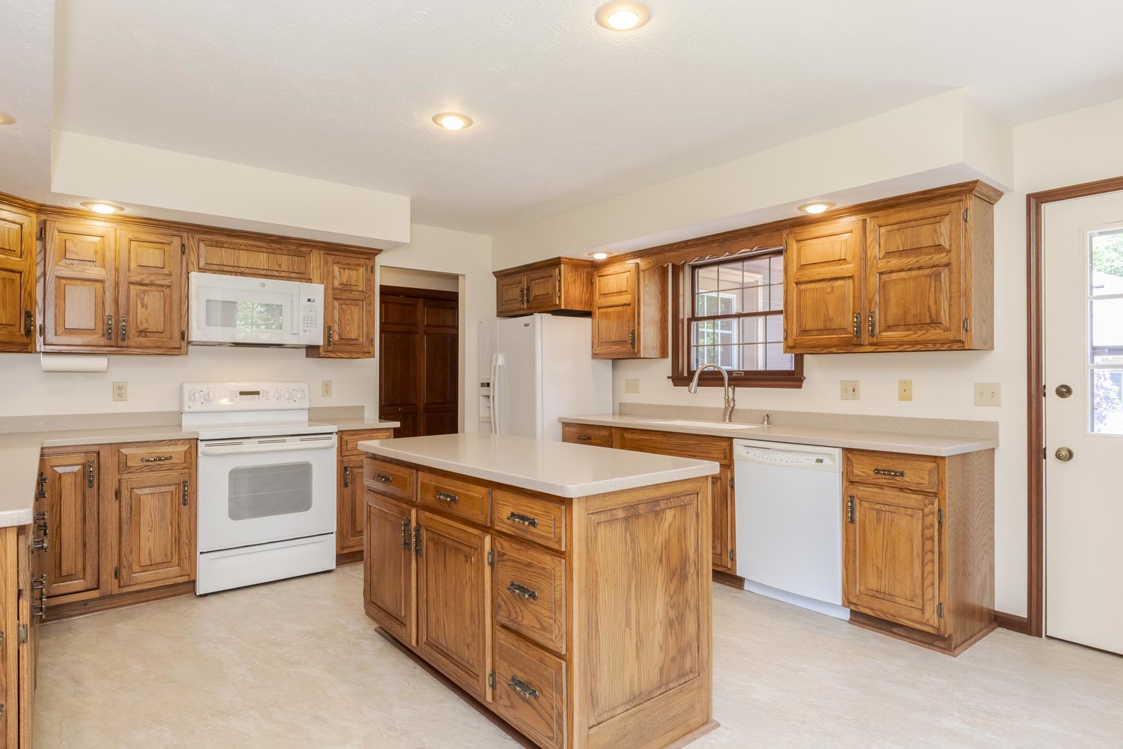 905 Rhymer Drive Normal, IL 61761 - Photo 13 of 47 a kitchen with white cabinets and white appliances