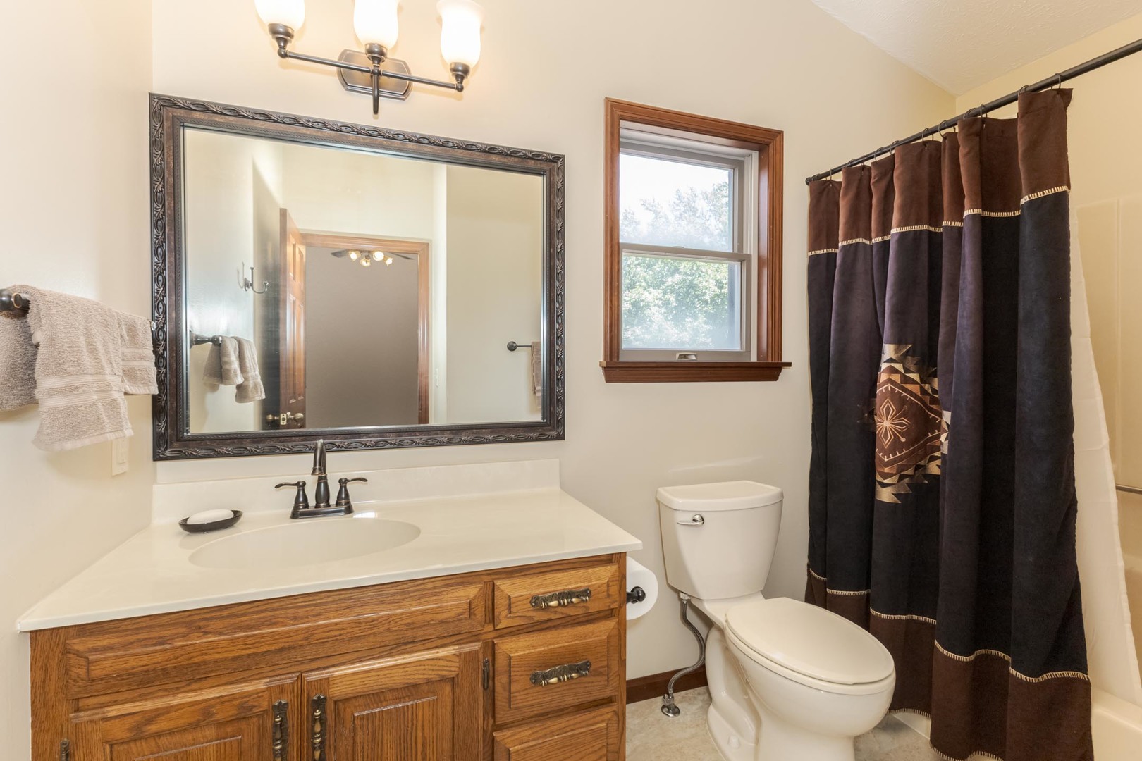905 Rhymer Drive Normal, IL 61761 - Photo 30 of 47 a bathroom with a sink a toilet a mirror and shower