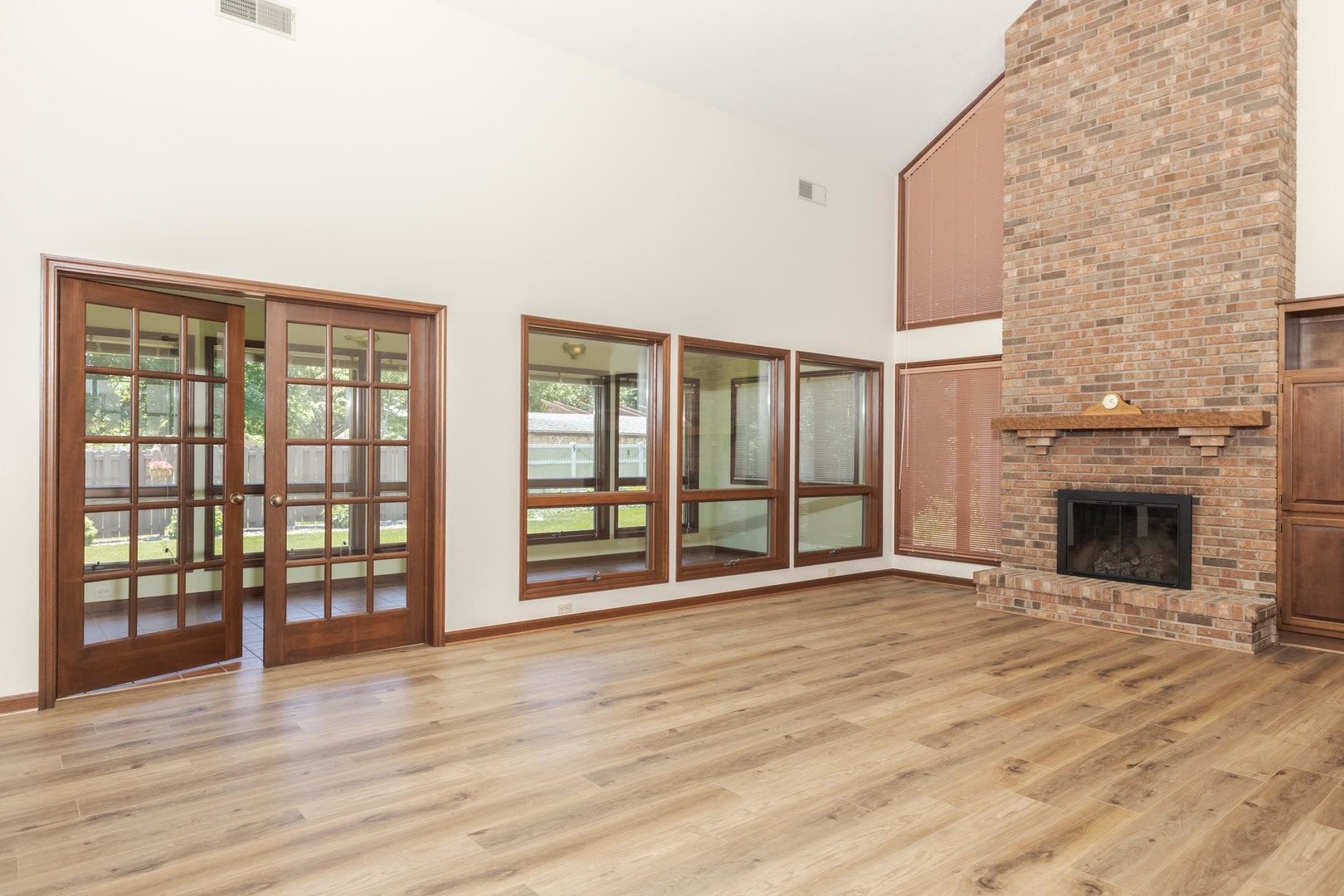 905 Rhymer Drive Normal, IL 61761 - Photo 6 of 47 an empty room with wooden floor and fireplace