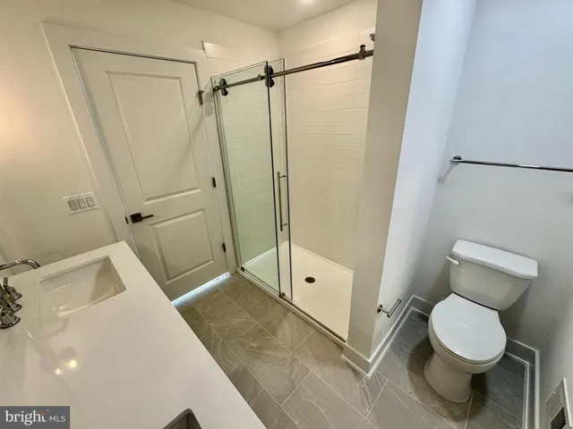 a bathroom with a toilet and a shower