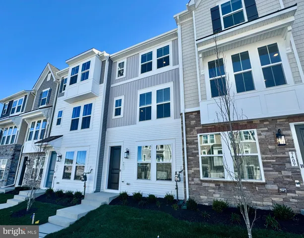 a front view of a building with windows and garden