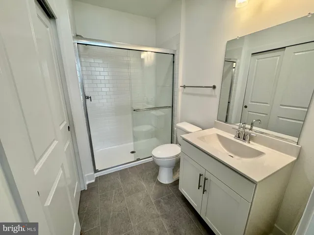 a bathroom with a toilet a sink and a mirror