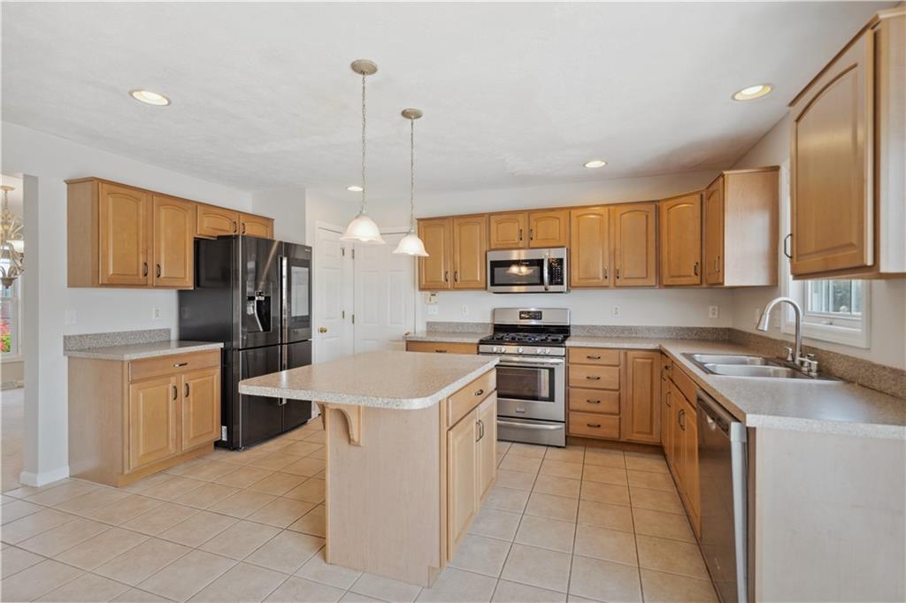 122 Walnut Circle Elizabeth, PA 15037 - Photo 11 of 50 a kitchen with stainless steel appliances granite countertop a sink a stove and a refrigerator