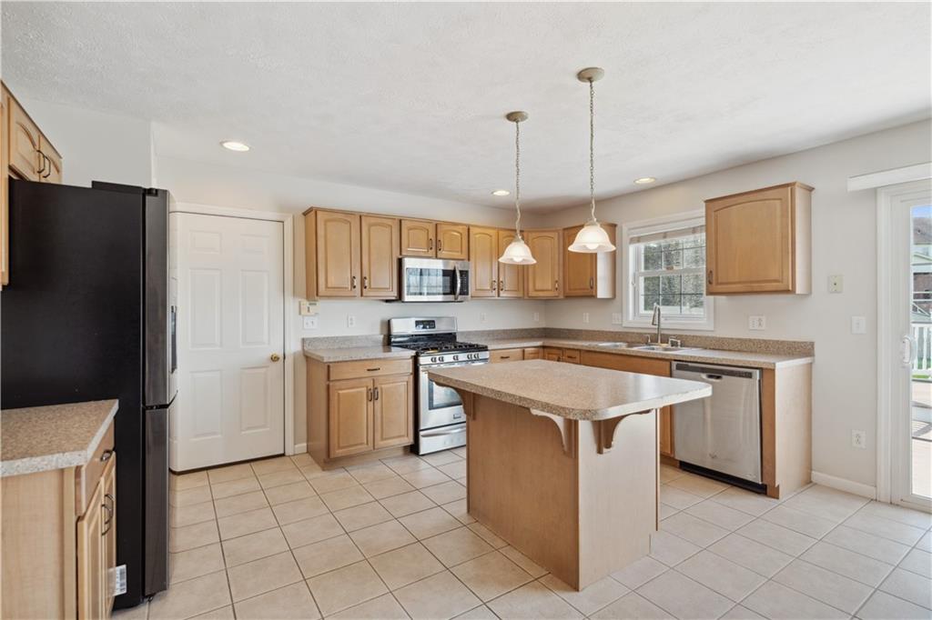 122 Walnut Circle Elizabeth, PA 15037 - Photo 12 of 50 a kitchen with kitchen island granite countertop a sink a counter top space and stainless steel appliances
