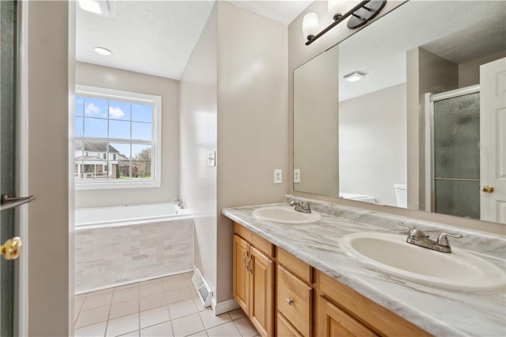 122 Walnut Circle Elizabeth, PA 15037 - Photo 34 of 50 a bathroom with a double vanity sink a mirror and a bathtub