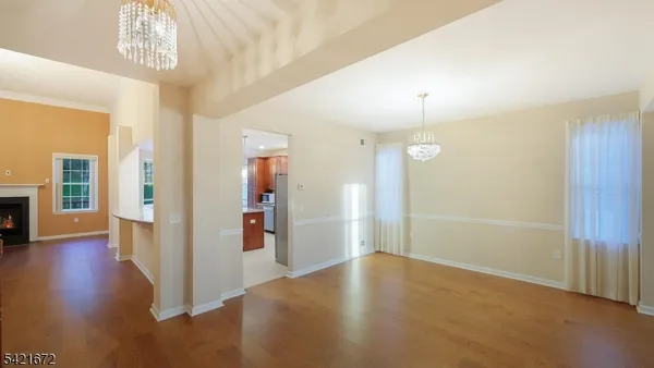 a view of a room with wooden floor