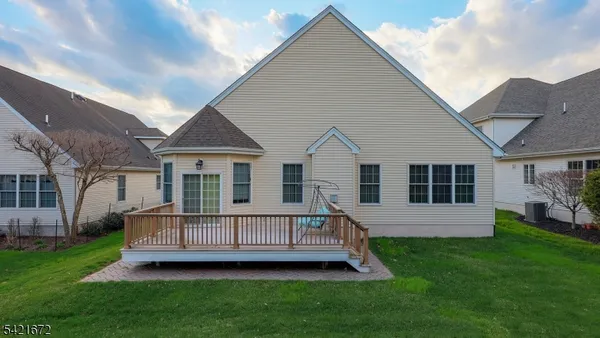 a view of a house with a yard and deck
