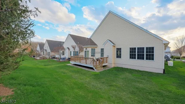 a view of a house with a yard and sitting area
