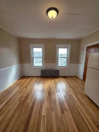 a view of a livingroom with wooden floor and an empty space