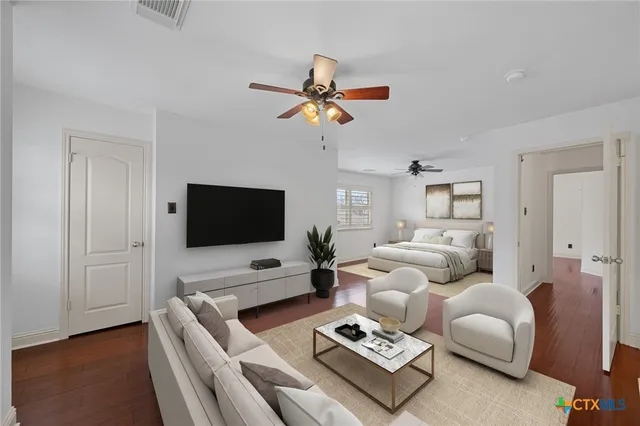 a living room with furniture a flat screen tv and a window