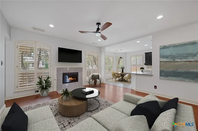 a living room with furniture a fireplace and a flat screen tv