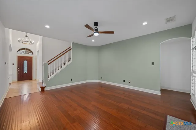 wooden floor in an empty room with a window