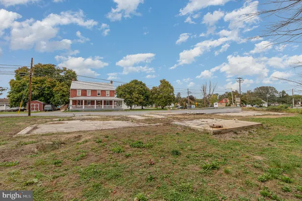 a swimming pool with outdoor seating and yard