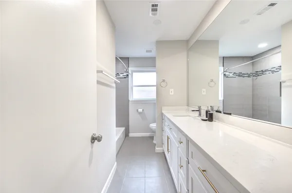 a bathroom with a double vanity sink and mirror