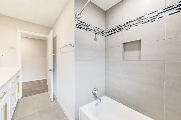 a bathroom with a bathtub and shower