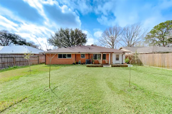 a front view of a house with a yard table and chairs