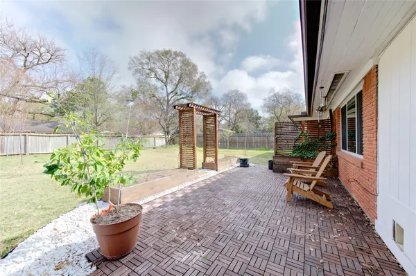 a view of a patio with a table and chairs