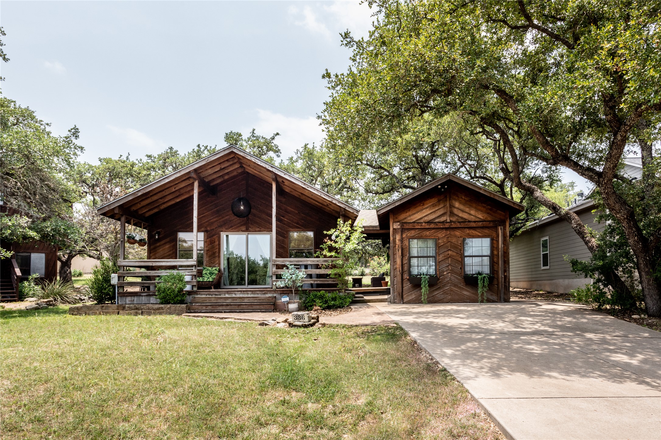336 Coventry Road Spicewood, TX 78669 - Photo 1 of 32 View of front of house with covered porch and a front lawn