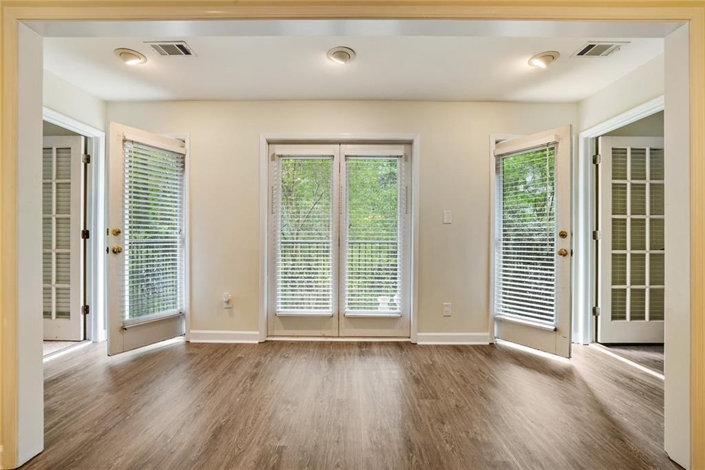 3203 Lenox Road Northeast, Unit 6 Atlanta, GA 30324 - Photo 8 of 27 an empty room with wooden floor and windows