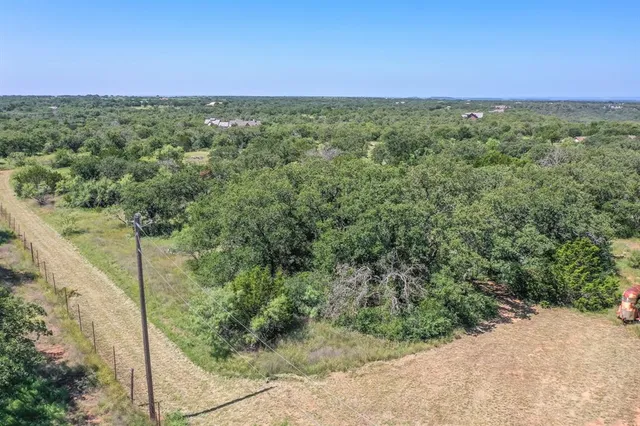 a view of a field with an trees in the background