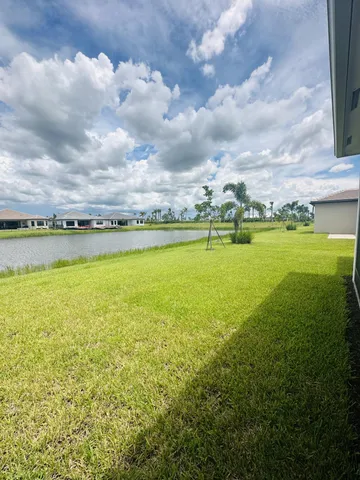 a view of a kitchen with a refrigerator and a chandelier