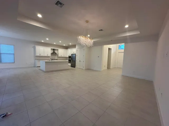 a kitchen with granite countertop white cabinets and stainless steel appliances