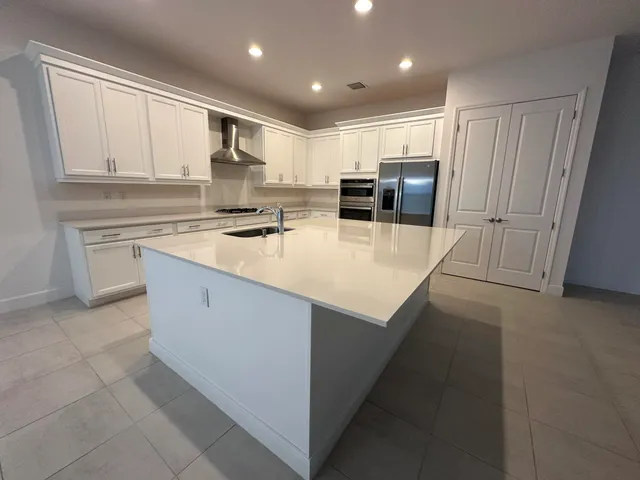 a large bathroom with a double vanity sink and mirror