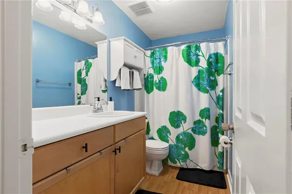 a bathroom with a potted plant and a sink