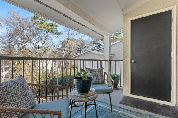 a view of a balcony with furniture