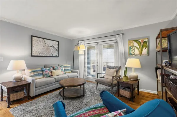 a living room with furniture and a lamp