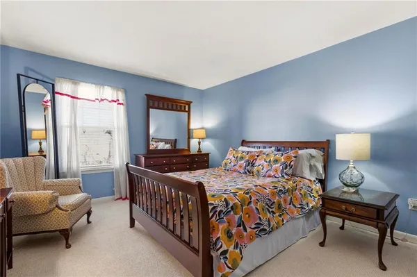 a bedroom with a bed and a couch