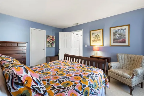 a bedroom with bed and a couch