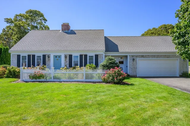 a view of a house with a yard and a porch