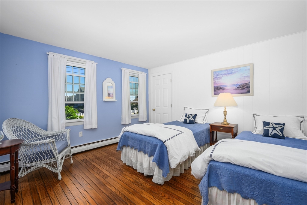 216 Forest Beach Road Chatham, MA 02659 - Photo 12 of 42 a bedroom with two beds and a potted plant