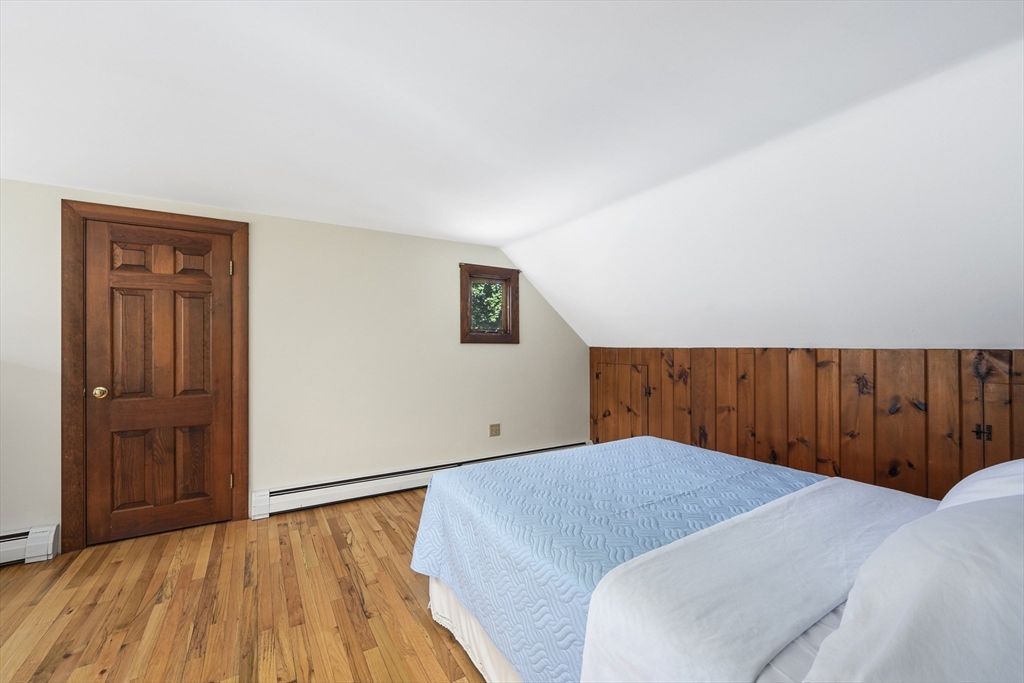 216 Forest Beach Road Chatham, MA 02659 - Photo 20 of 42 a bedroom with a bed and wooden floor