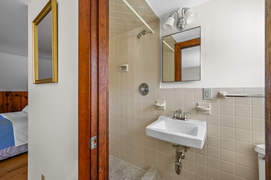 216 Forest Beach Road Chatham, MA 02659 - Photo 23 of 42 a bathroom with a sink a mirror and a shower