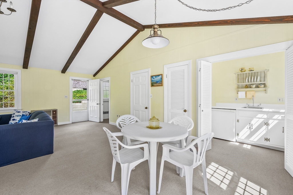 216 Forest Beach Road Chatham, MA 02659 - Photo 28 of 42 a view of a dining room with furniture and a chandelier