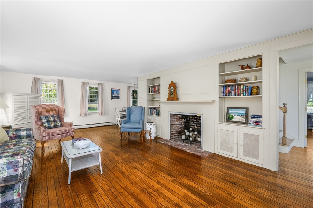 216 Forest Beach Road Chatham, MA 02659 - Photo 3 of 42 a living room with furniture and a fireplace
