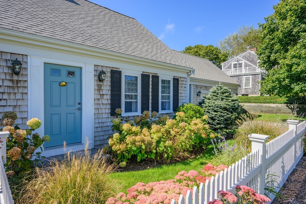 216 Forest Beach Road Chatham, MA 02659 - Photo 37 of 42 a front view of a house with a yard and fountain