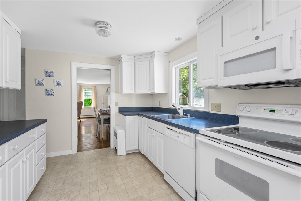 216 Forest Beach Road Chatham, MA 02659 - Photo 6 of 42 a kitchen with stainless steel appliances granite countertop a sink stove and cabinets