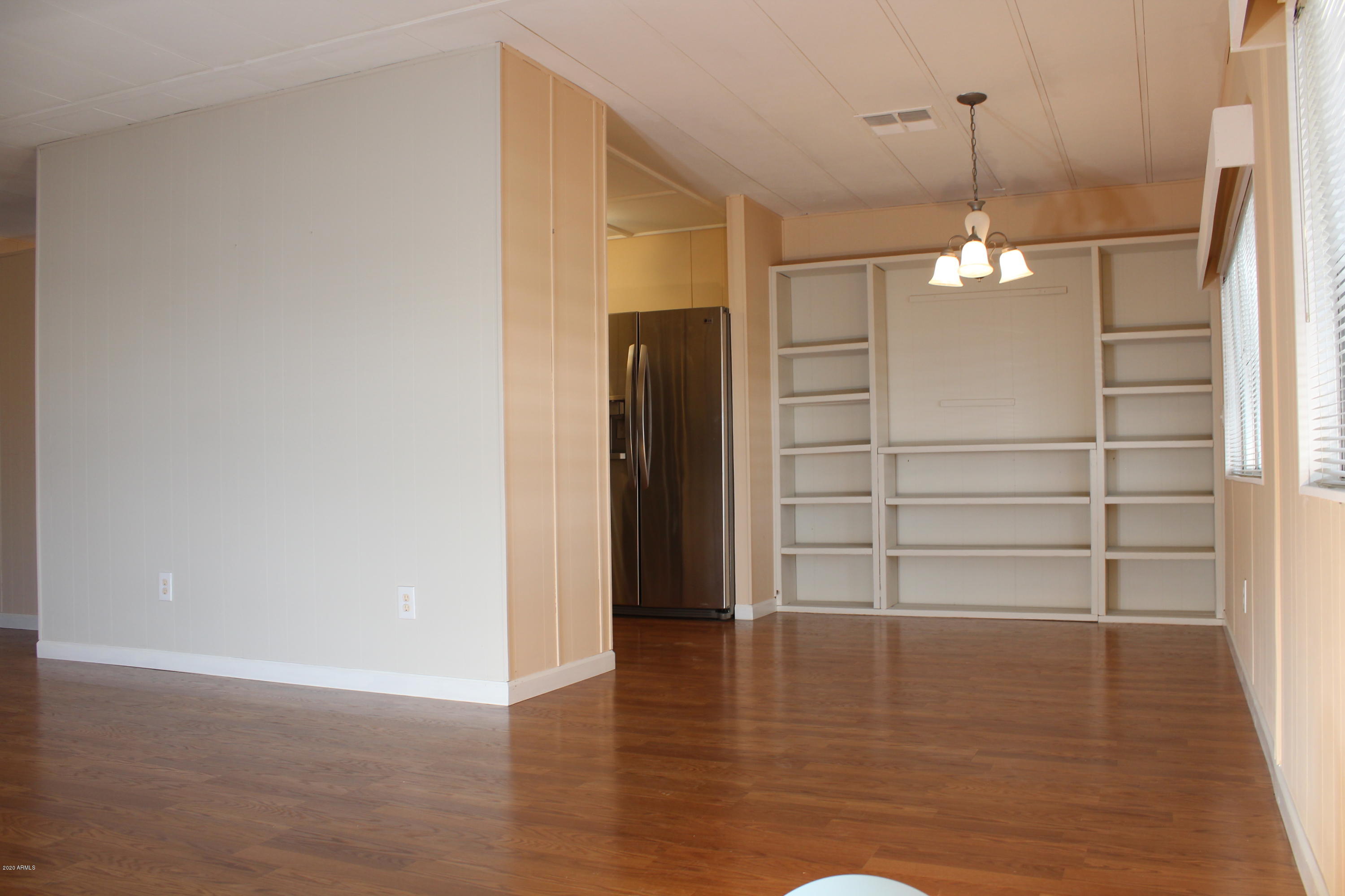301 South Signal Butte Road, Unit 626 Apache Junction, AZ 85120 - Photo 7 of 28 a view of a room with wooden floor and white walls