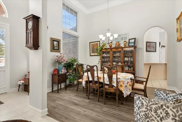 a view of a dining room with furniture and chandelier