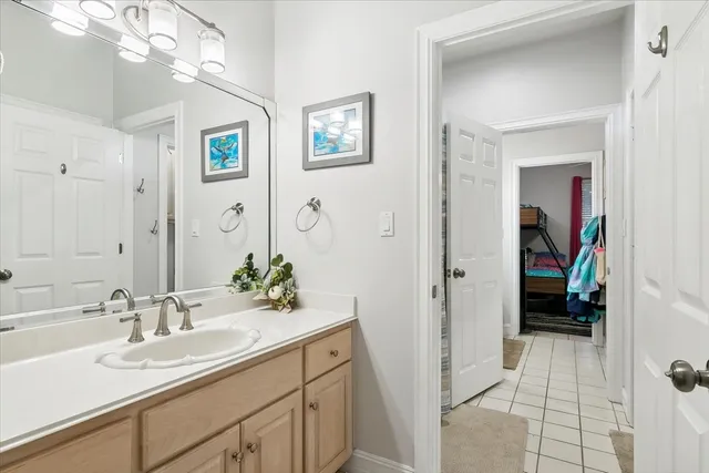 a en suite bathroom with a double vanity sink mirror and