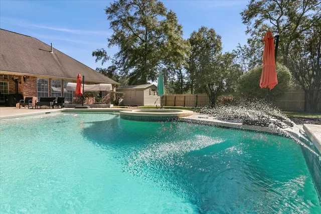 a swimming pool view with a outdoor seating