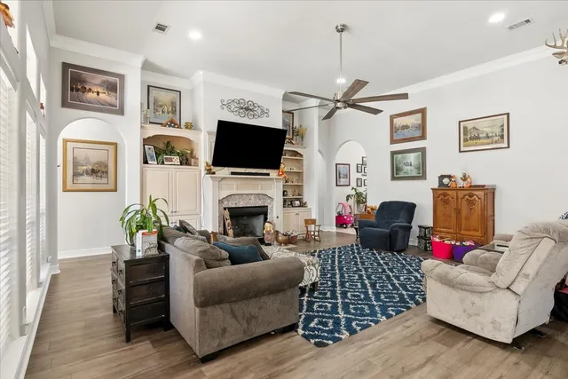a living room with furniture a flat screen tv and a fireplace