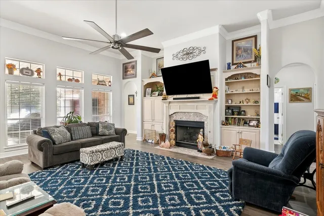 a living room with furniture a flat screen tv and a fireplace