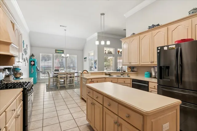 a kitchen that has a lot of cabinets in it and appliances